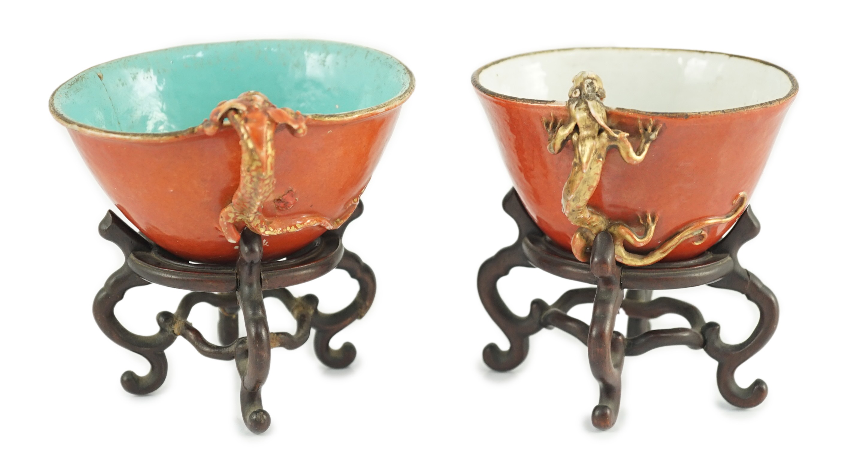 Two similar Chinese coral ground libation cups, late 18th/early 19th century, 10.5cm and 11.5cm across, wood stands